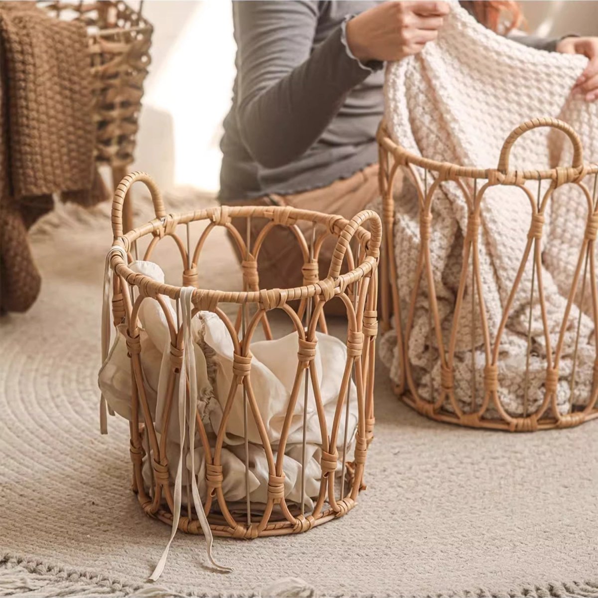 Woven baskets with blankets on a neutral background
