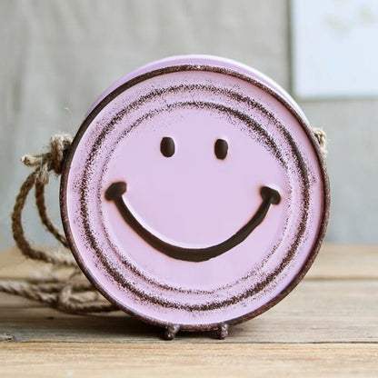 smiley face hanging planter in pink